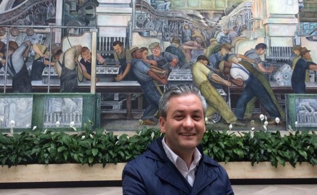 Robert Biedron in front of iconic Diego Rivera mural in Detroit Institute of Arts