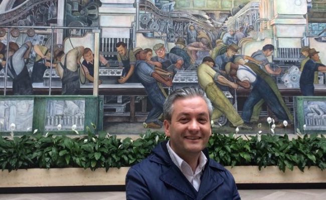 Robert Biedron in front of iconic Diego Rivera mural in Detroit Institute of Arts